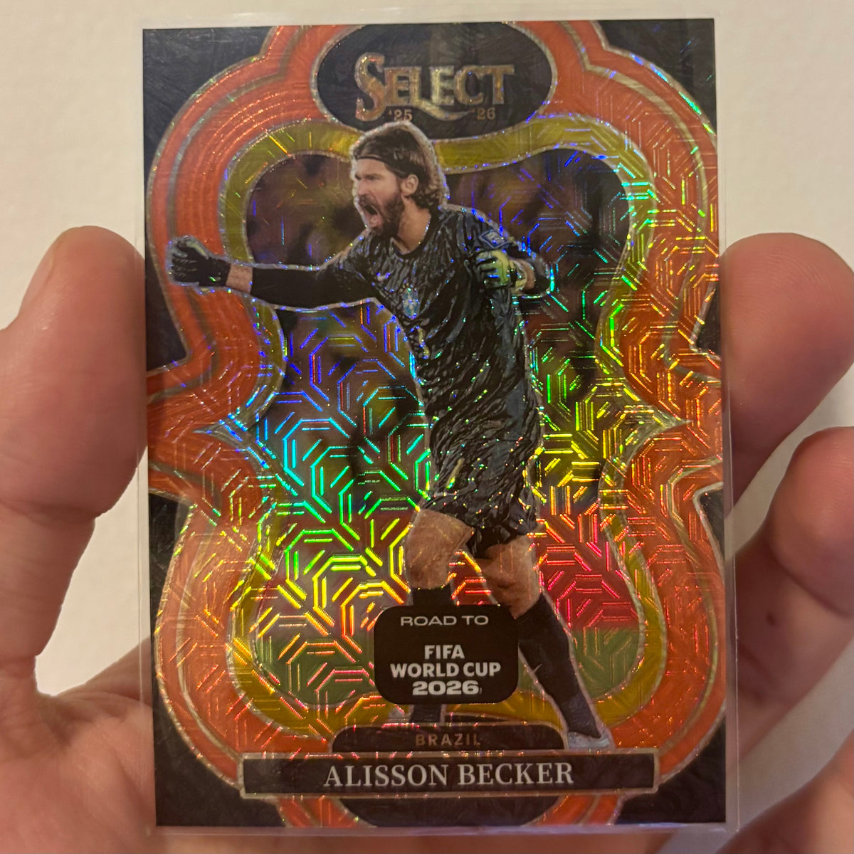Alisson Becker #196 Orange Mojo Prizm 307/825 – Panini Select 2025-26
